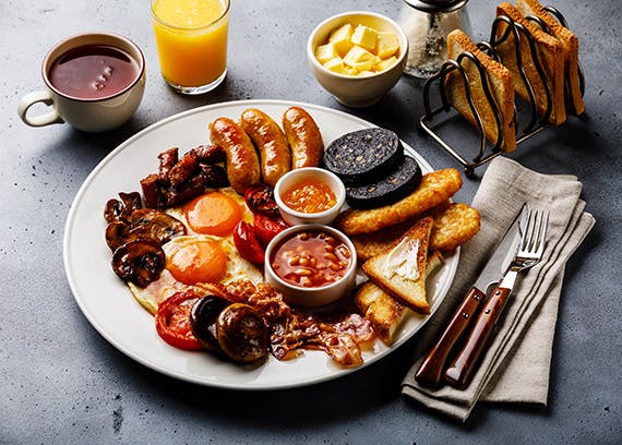 A full English breakfast served with coffee and orange juice