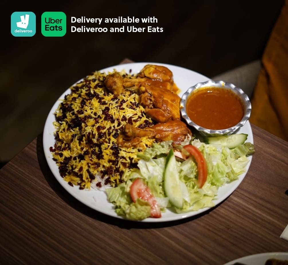 Hot chicken served with yellow rice, spicy sauce, and salad. Deliveroo and Uber Eats