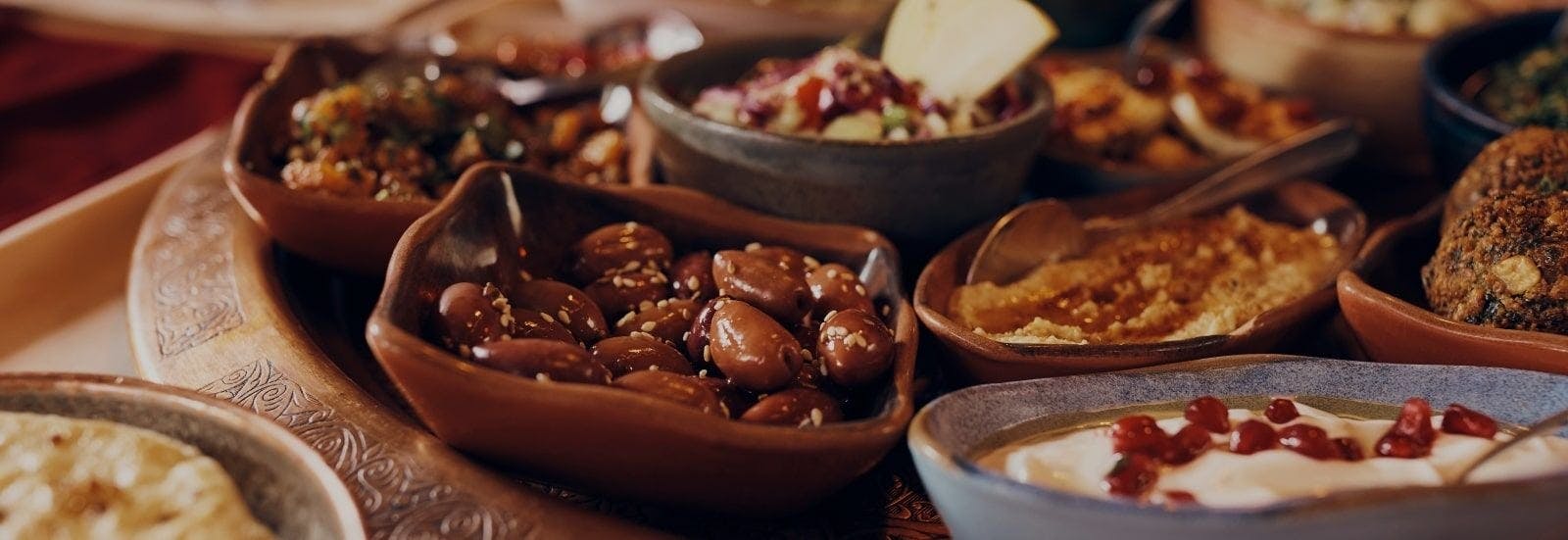 A platter of small Turkish dishes including olives