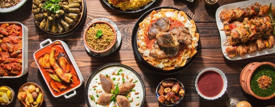 Bowls and dishes of traditional Turkish dishes served on a wooden table