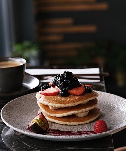 Pancakes with strawberries, blackberries and bananas served at Elif (Shepherds Bush)