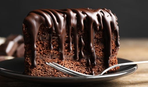 Chocolate fudge cake drizzled in chocolate sauce