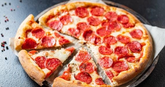 A hot pepperoni pizza carved into slices