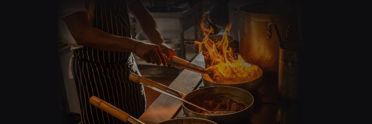 Chef cooking signature dishes at Sasas Indian Bar and Kitchen (Malmesbury)