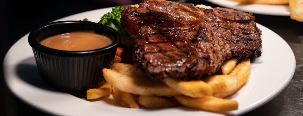 T-bone steak with chips and sauce at Meat Up Spot (Swansea)