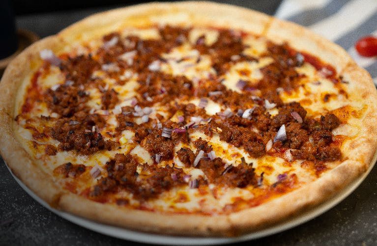 Beef and onion pizza served at Deep Pan Pizza (Clapton)