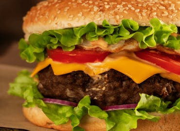 Loaded with salad and topped with our signature burger sauce! Order now!